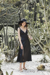 Silk slip dress with adjustable tie straps and deep neckline in lightweight satin finish